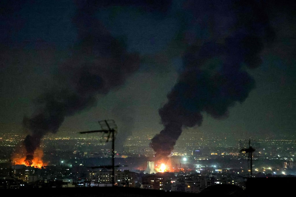 Tall plumes of smoke billow from fires near Azadi Tower in Tehran on Saturday. Photo: AFP
