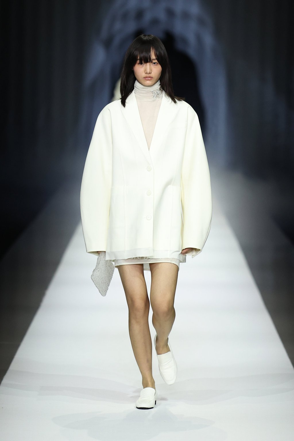Rounded, flowing sleeves soften a crystalline white coat at Anteprima’s fall/winter 2026 runway at Milan Fashion Week. Photo: Getty Images