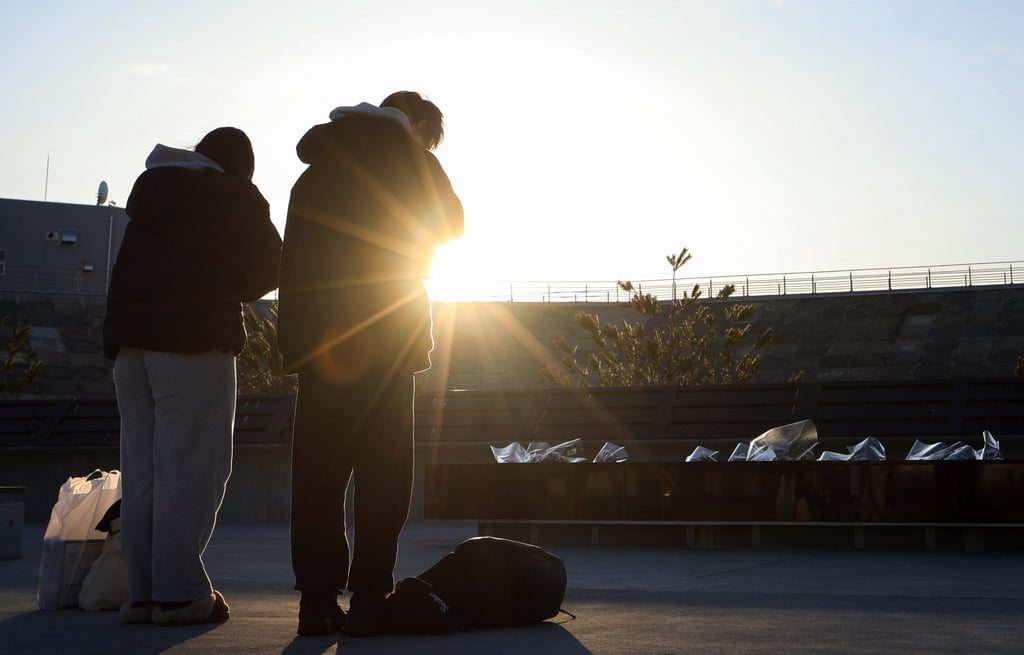 People pay their respects to the victims of the 2011 tsunami in Otsuchi, Iwate prefecture, on Wednesday. Photo: Jiji Press/ EPA