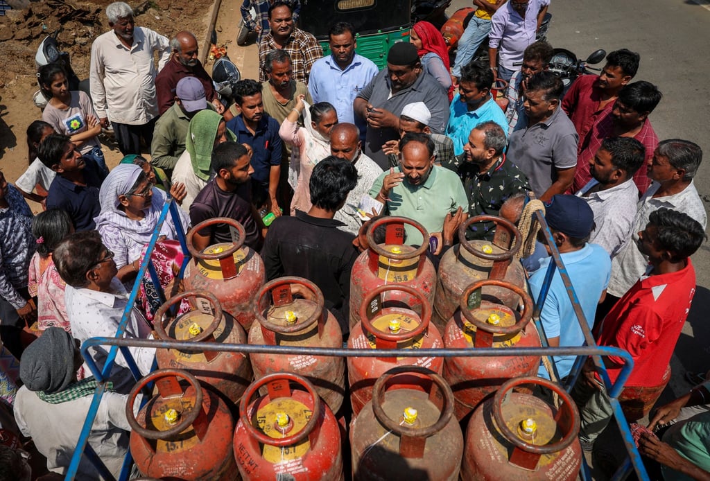 People surround a vehicle loaded with LPG cylinders in Ahmedabad, India, on Thursday. Photo: Reuters