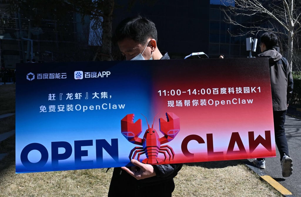 A man holds a placard featuring OpenClaw, an open-source AI assistant in Beijing. Photo: AFP