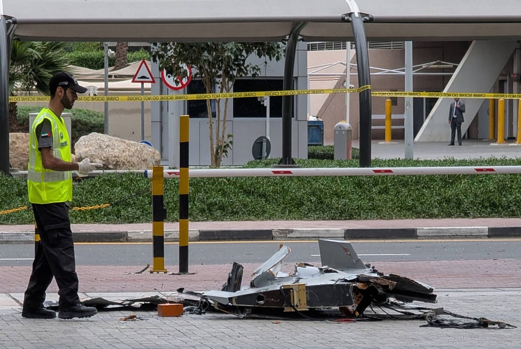 A policeman inspects the wreckage of a drone in downtown Dubai on Thursday. Photo: AFP