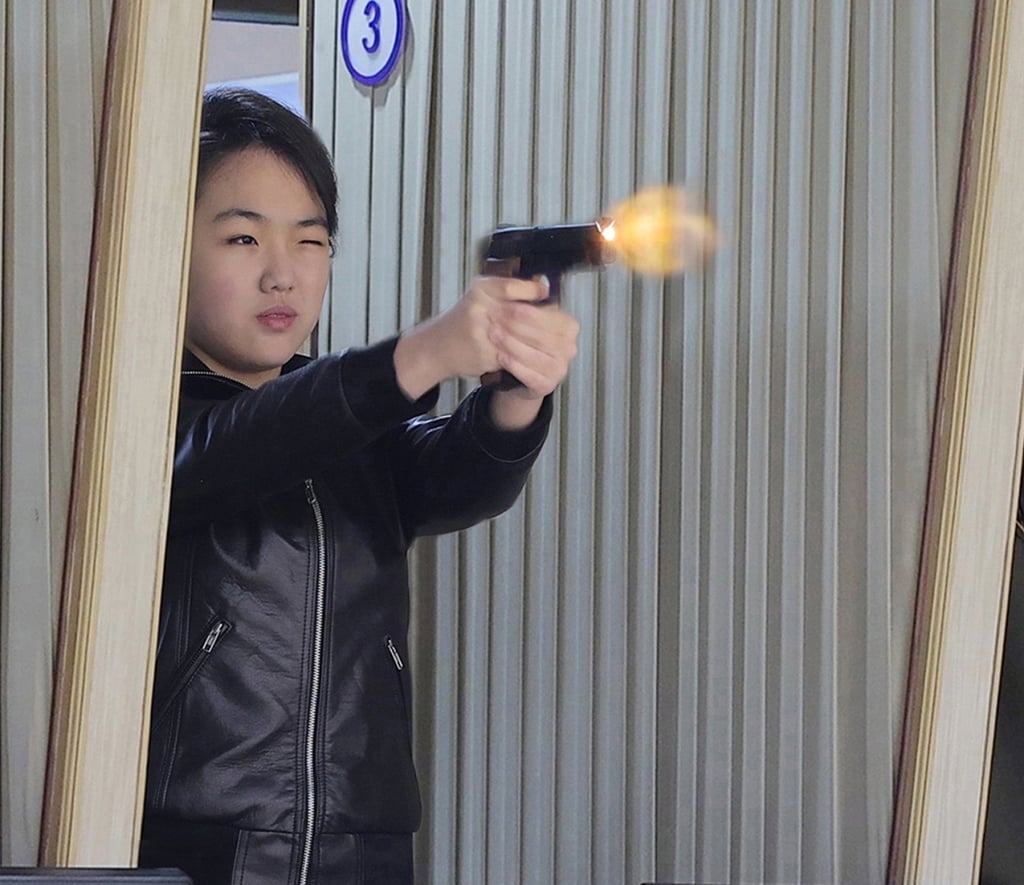 Kim Ju-ae, daughter of North Korean leader Kim Jong-un, test fires a new-type pistol during an inspection of a major munitions factory on Wednesday. Photo: KCNA/EPA Kim Ju-ae, daughter of North Korean leader Kim Jong-un, test fires a new-type pistol during an inspection of a major munitions factory on Wednesday. Photo: KCNA/EPA