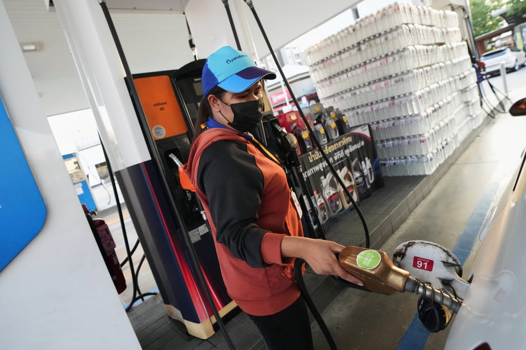 A petrol station attendant fills the tank of a car in Bangkok on Monday. Photo: AP A petrol station attendant fills the tank of a car in Bangkok on Monday. Photo: AP