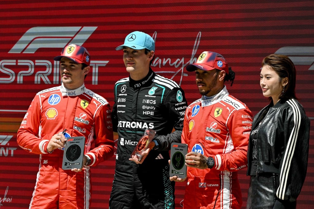 Winner George Russell (second from left), second-placed Charles Leclerc (left) and third-placed Lewis Hamilton with Chinese athlete Wu Yanni. Photo: AFP