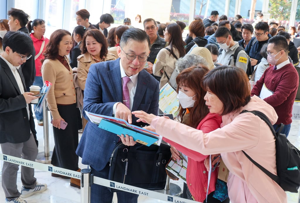 Prospective buyers pore over project literature for the Cloudview project on the first day of sales at AXA Tower, Landmark East, Kwun Tong on Saturday. Photo: Dickson Lee