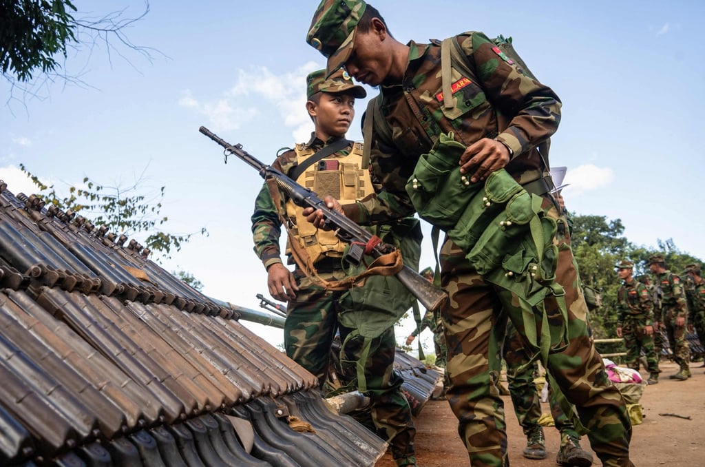 Members of Ta’ang National Liberation Army receive military equipment at a graduation ceremony after getting special combat training in Myanmar’s northern Shan State. Photo: AFP