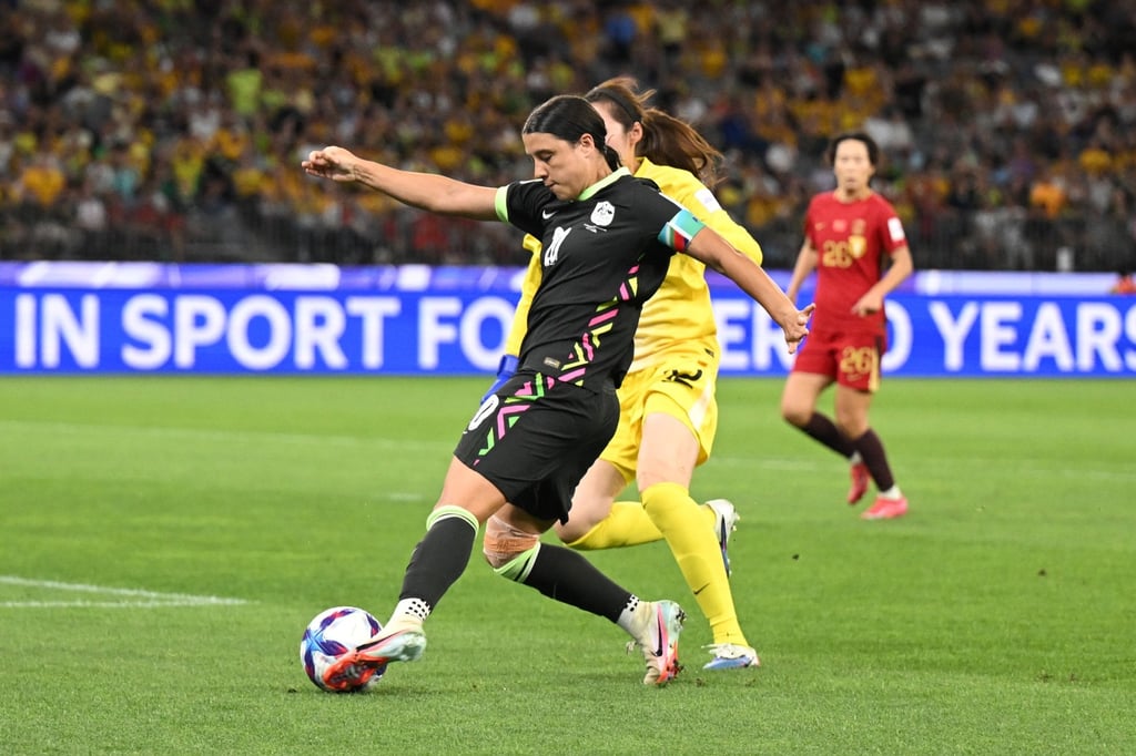 Australia’s Sam Kerr (left) scores the goal that sends her side into the Women’s Asian Cup final. Photo: EPA
