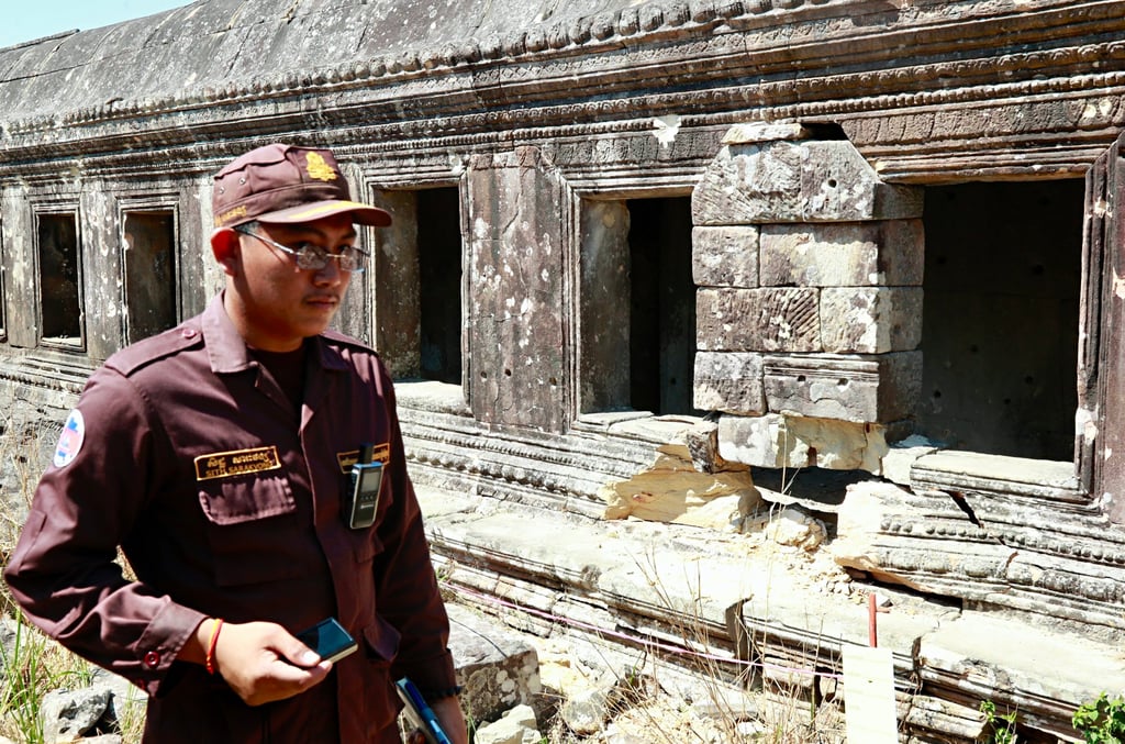 A member of the Cambodian Mine Action Centre walks through the scarred Preah Vihear temple grounds on Friday. The 1,000-year-old temple sustained significant damage during last year’s clashes. Photo: EPA
