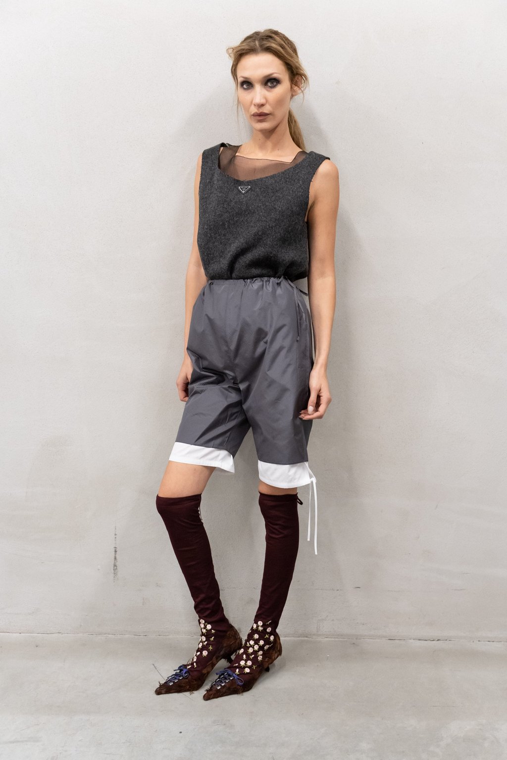 Bella Hadid sporting the “tired girl” look at Prada, complete with smudged charcoal eyes. Photo: Handout