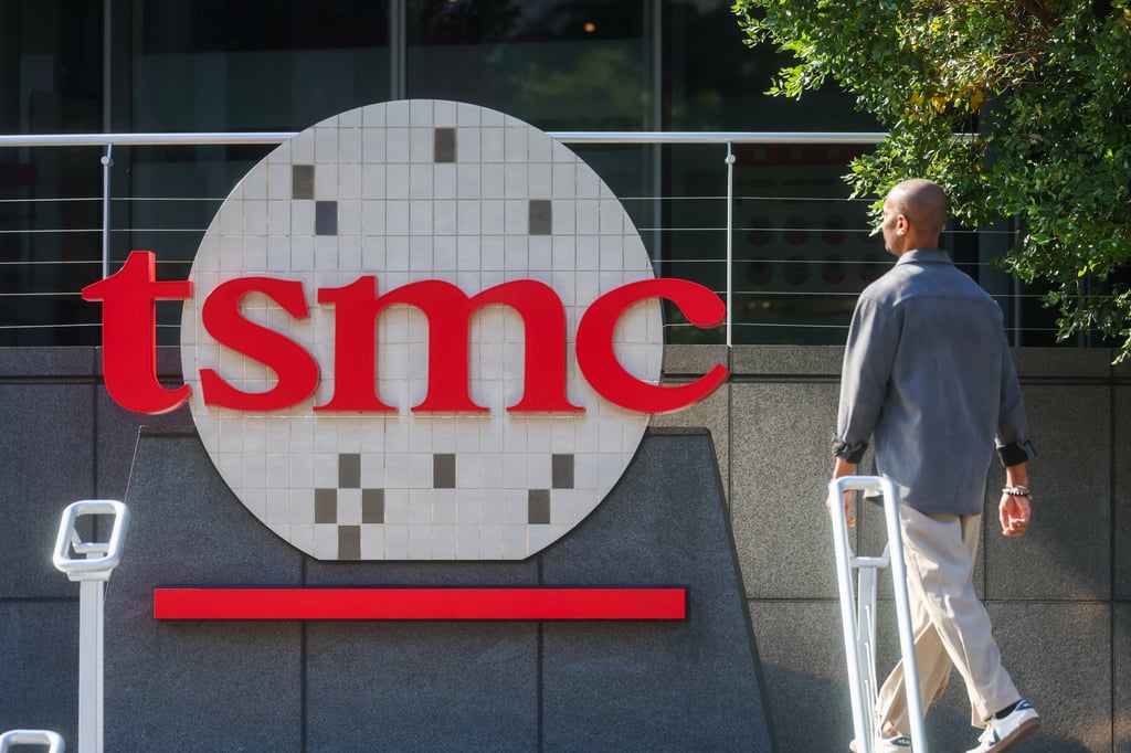 A worker walks past the logo of TSMC or Taiwan Semiconductor Manufacturing Corp in Hsinchu, Taiwan. Photo: AP
