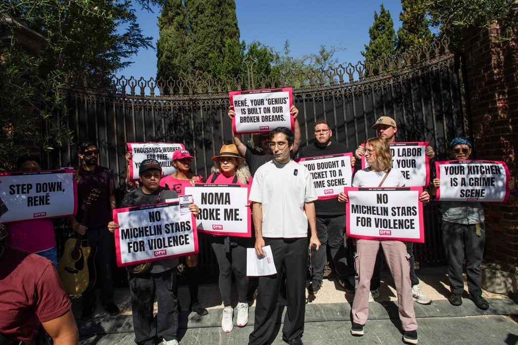 Jason Ignacio White (centre), former head of Noma’s fermentation lab, stands with activists and restaurant workers in front of Noma’s pop-up in Los Angeles on March 11, 2026. Photo: AFP