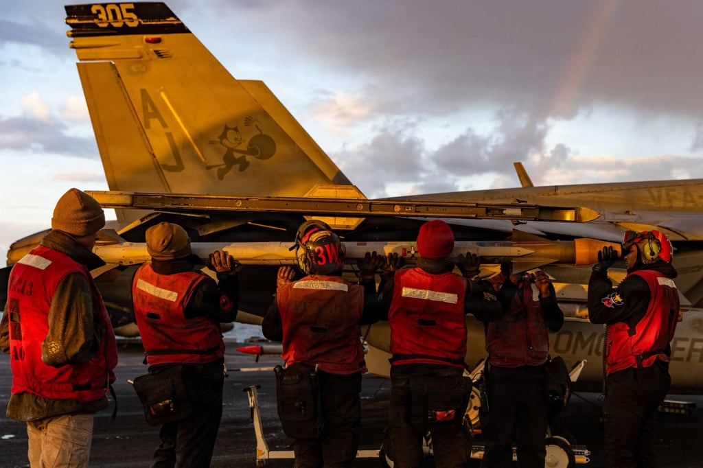 US Navy crew load ordnance onto an F/A-18E Super Hornet. Photo: US Navy via Reuters