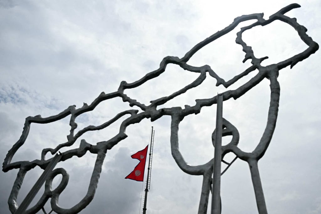 Nepal’s national flag is seen flying at half-mast through a structure built in the shape of country’s map in Kathmandu last September following that month’s deadly unrest. Photo: AFP