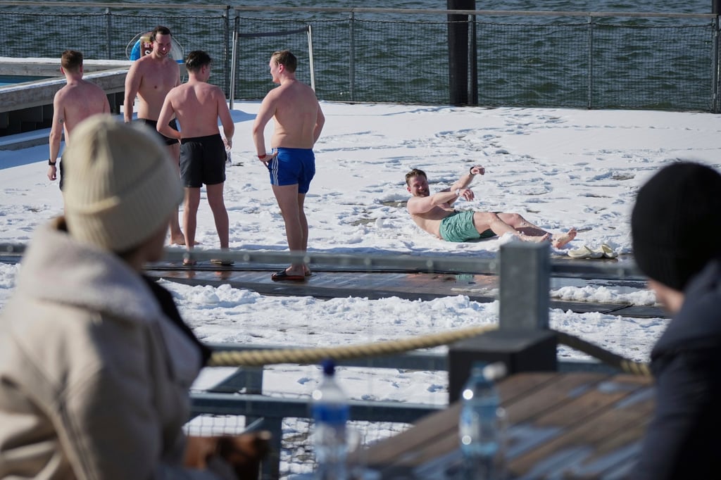 People spend time outside after using the sauna of a public bath in Helsinki, Finland. Photo: AP