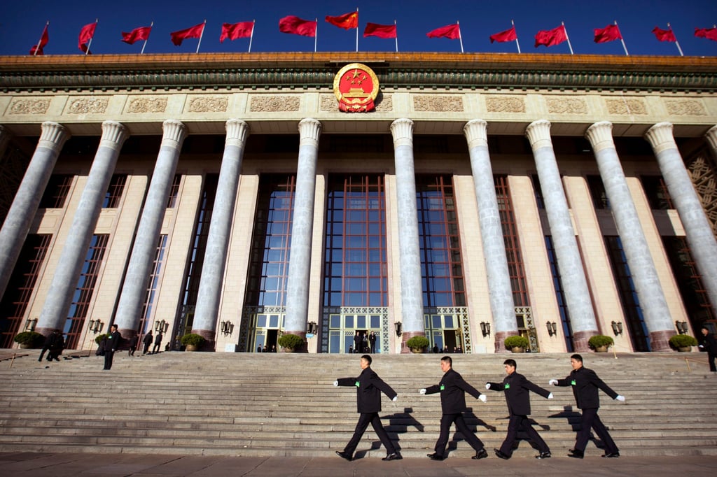Security personnel march in front of the Great Hall of the People in Beijing. Photo: AP