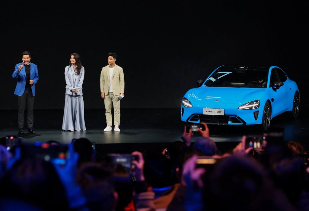 Lei Jun, left, with actress Shu Qi and athlete Su Bingtian at the launch in Beijing. Photo: Reuters