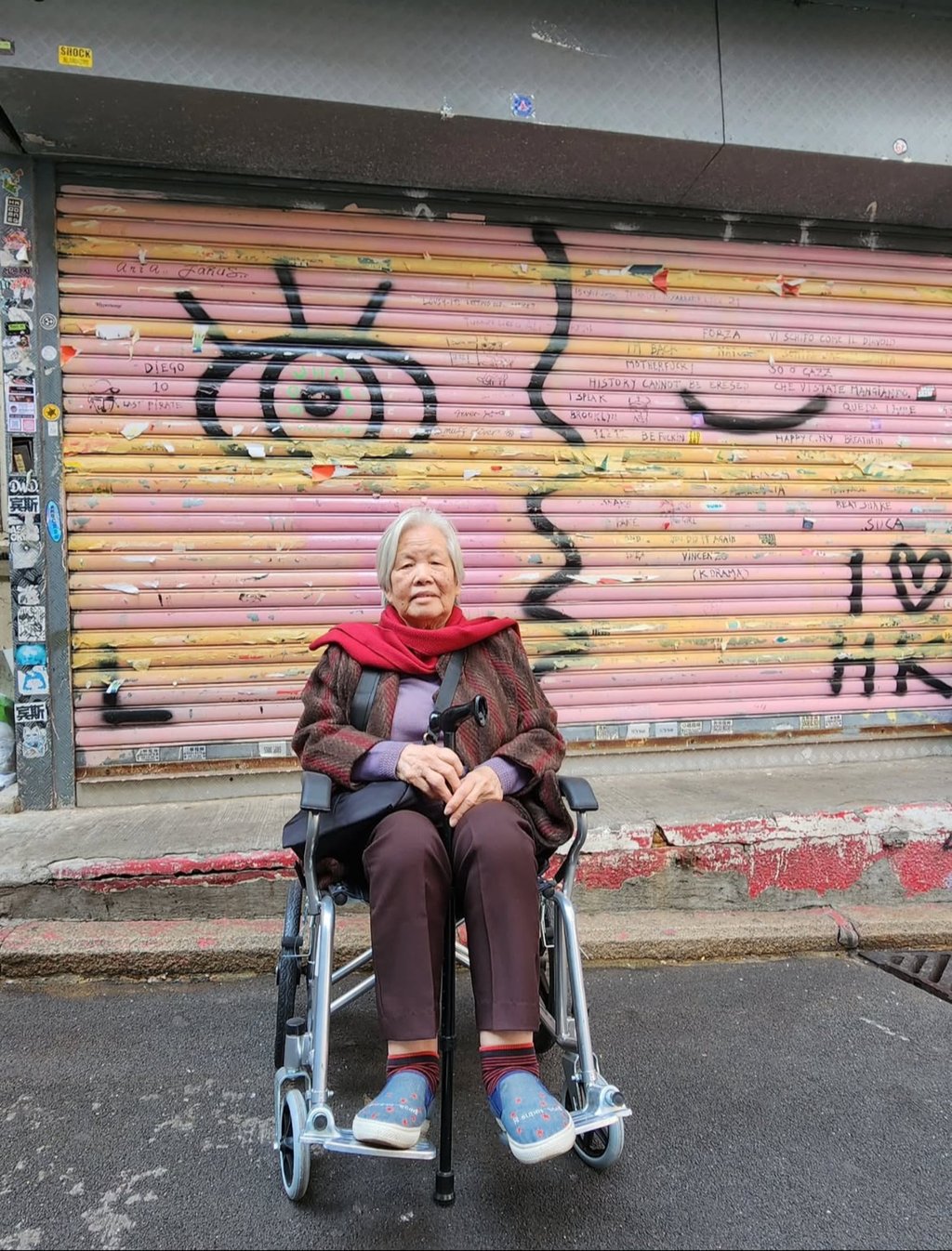 A passer-by poses in front of one of Lousy’s artworks, which can be seen across Hong Kong’s streets. Photo: Handout
