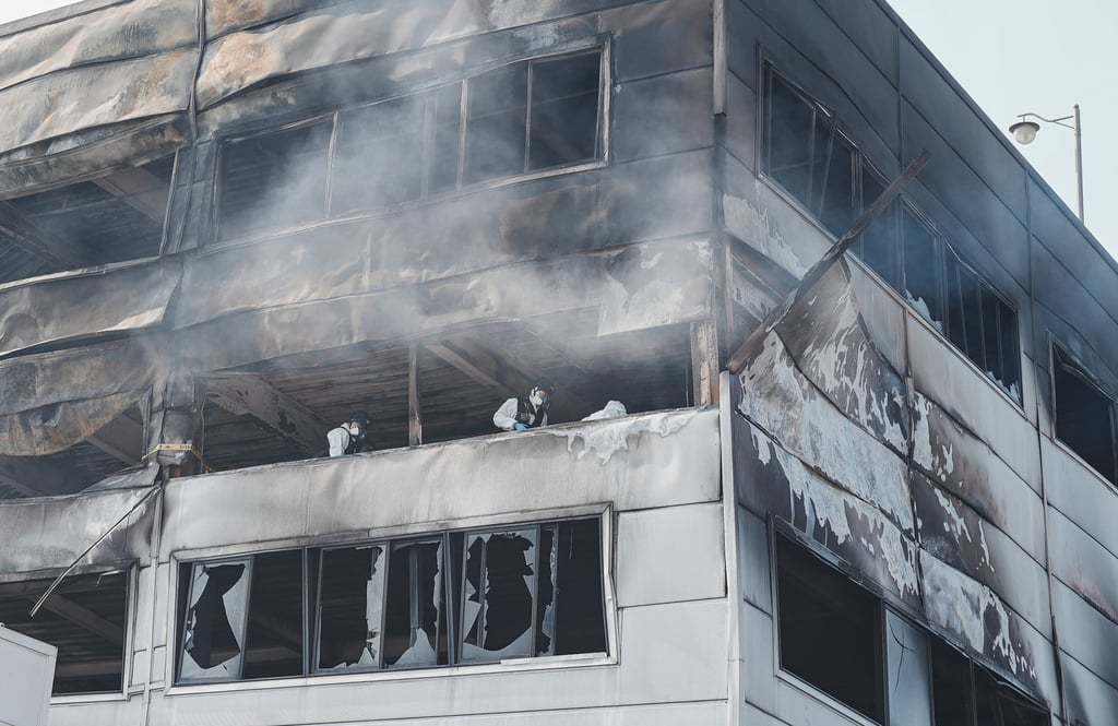 Firefighters and forensics teams work at the fire-damaged factory in Daejeon on Saturday. Photo: Xinhua