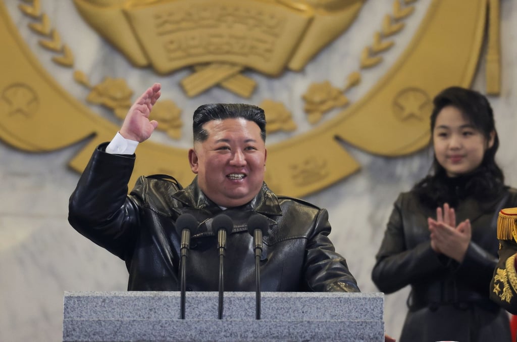 North Korean leader Kim Jong-un gestures while his daughter, believed to be named Kim Ju-ae, looks on during a military parade in Pyongyang on Wednesday. Photo: EPA/KCNA