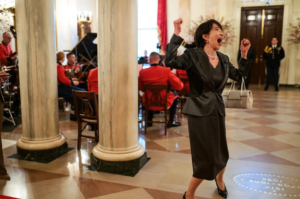 A White House photograph shows Takaichi arriving at an official dinner with her fists raised, handbag over one arm, apparently shouting with delight. Photo: White House
