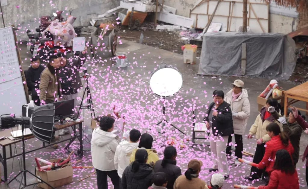 Pink confetti-like pieces fill the air as the aunties perform. Photo: mp.weixin.qq.com
