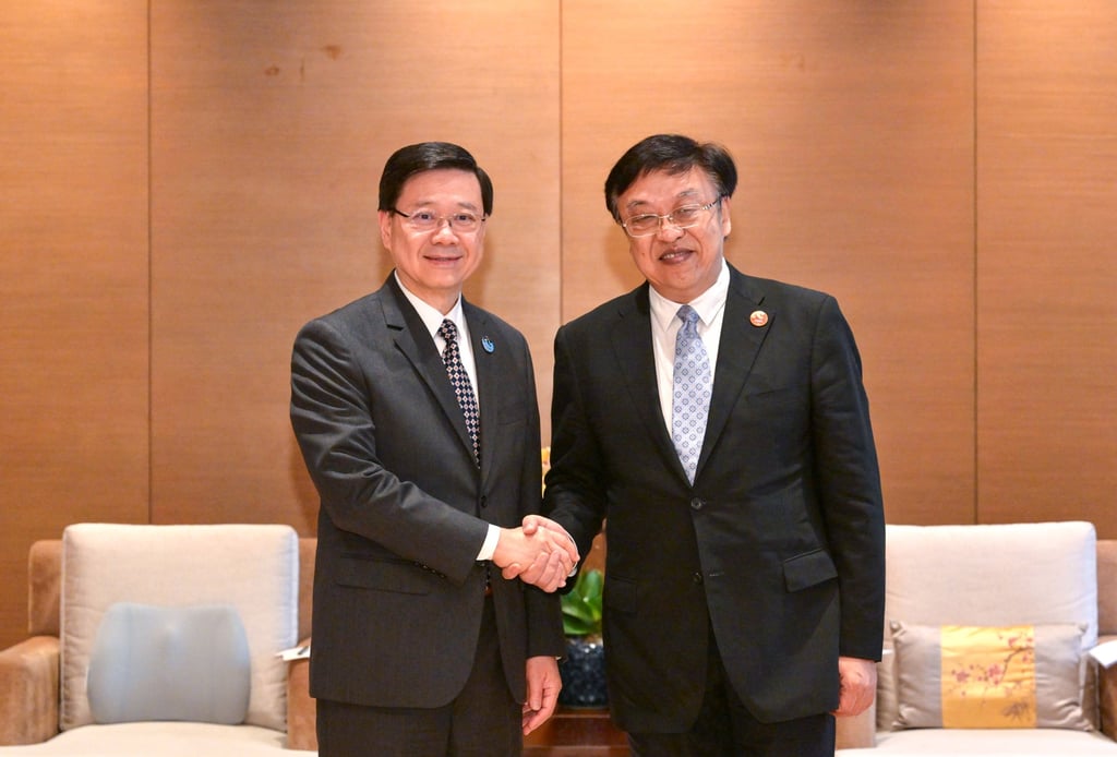 John Lee (left) meets Hainan party secretary Feng Fei on Wednesday. Photo: Handout