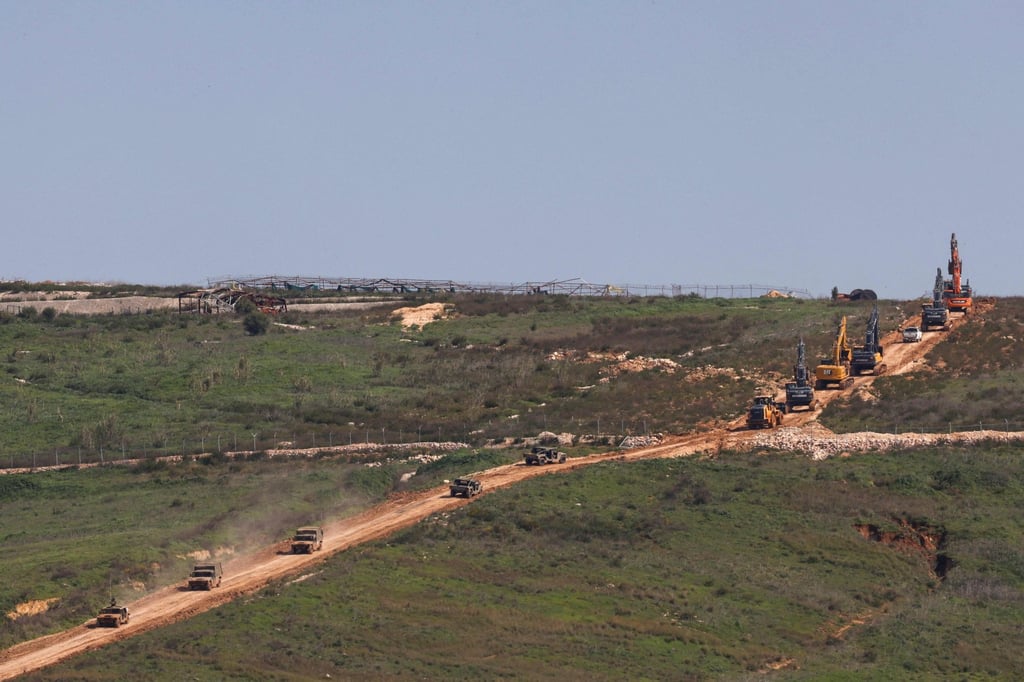 Heavy equipment accompanied by military vehicles cross from Israel into southern Lebanon on Tuesday. Photo: AFP