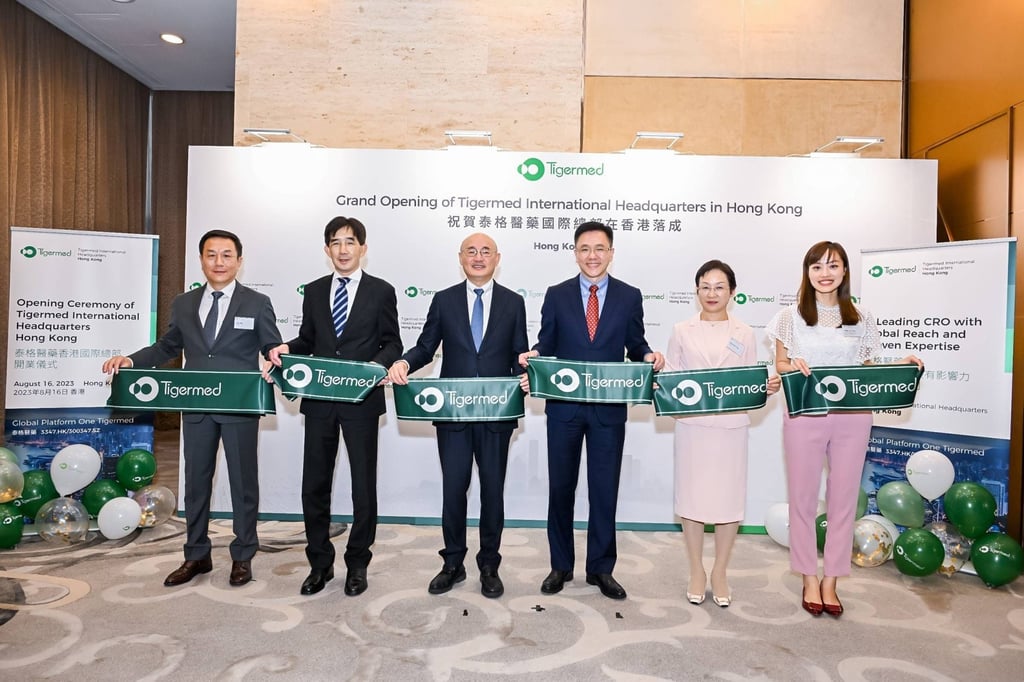 Hao Wu (far left), Tigermed’s executive director and co-president, joins colleagues and Hong Kong Secretary for Innovation, Technology and Industry Sun Dong (third right) at the opening ceremony of Tigermed’s international headquarters in Hong Kong in 2023.