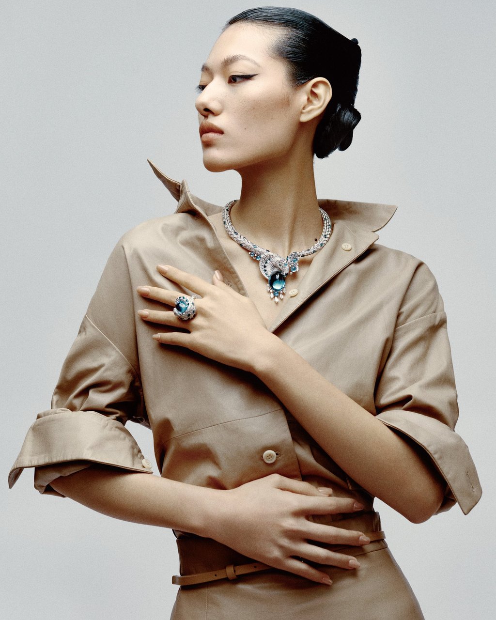 Necklace, ring: Cartier. Shirt, skirt, belt: Max Mara