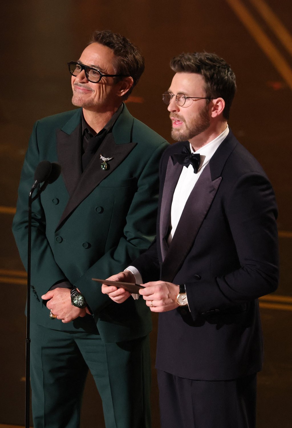 Robert Downey Jr and Chris Evans speak onstage during the 98th Oscars, on March 15. Photo: Getty Images/AFP