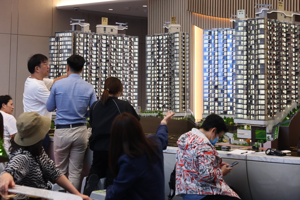 Home buyers inspect a model of a new development at a sales office in Tuen Mun, November 25, 2025. Photo: Dickson Lee Home buyers inspect a model of a new development at a sales office in Tuen Mun, November 25, 2025. Photo: Dickson Lee