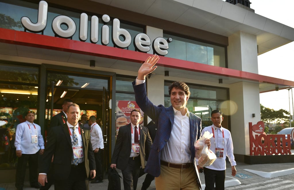 Canada’s then-prime minister Justin Trudeau (centre) waves after visiting a Jollibee in Manila in 2017. Photo: AFP