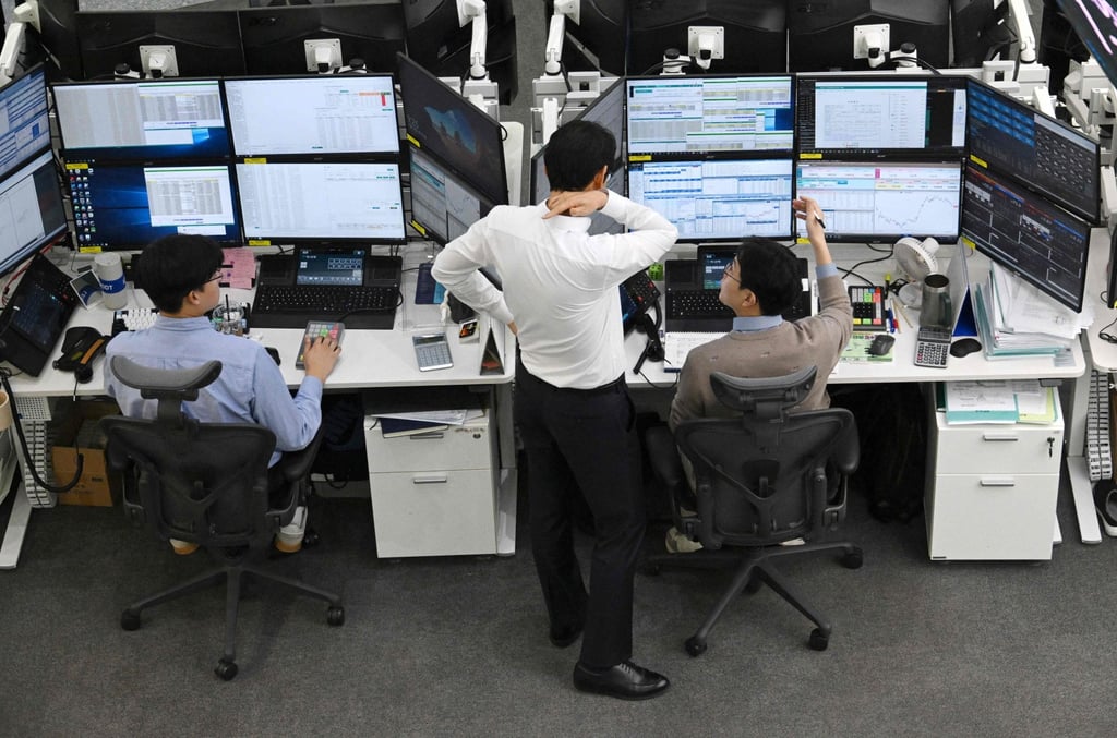 Currency dealers monitor exchange rates at the Hana Bank headquarters in Seoul on March 3. South Korea’s won tumbled to its lowest level in 17 years this month. Photo: AFP