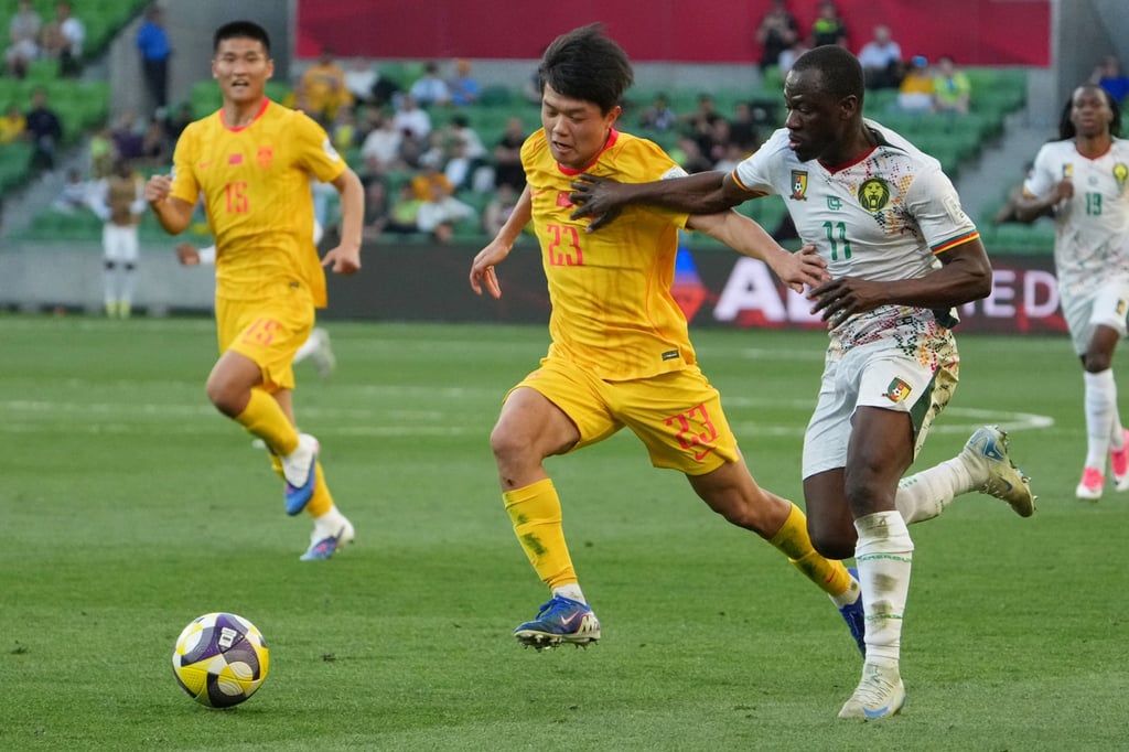 Cameroon's goal scorer, Saidou Alioum (right) faces China's Yang Alex. Photo: AP