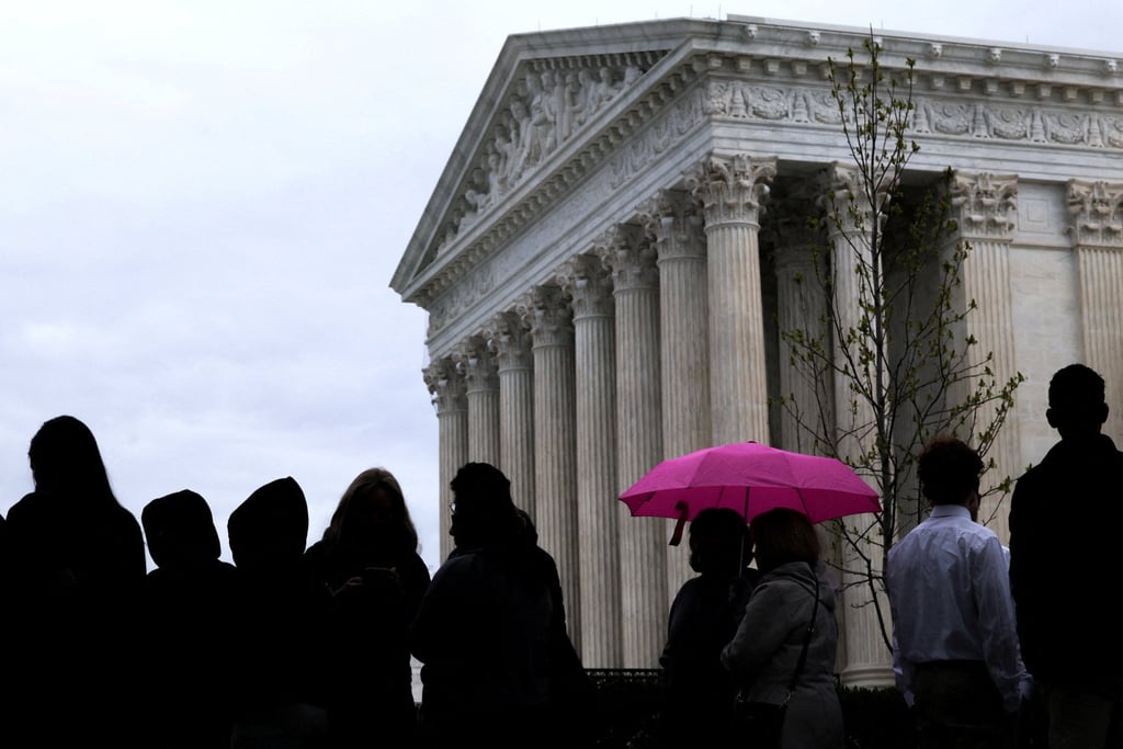Visitors line up outside the US Supreme Court building to watch proceedings. Photo: Reuters