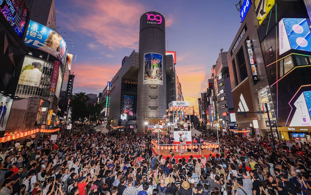 Locals and foreign tourists alike crowd the streets to watch dancing and a drum performance during the Shibuya Bon Odori Festival in August 2025. Photo: Jiji Press/AFP
