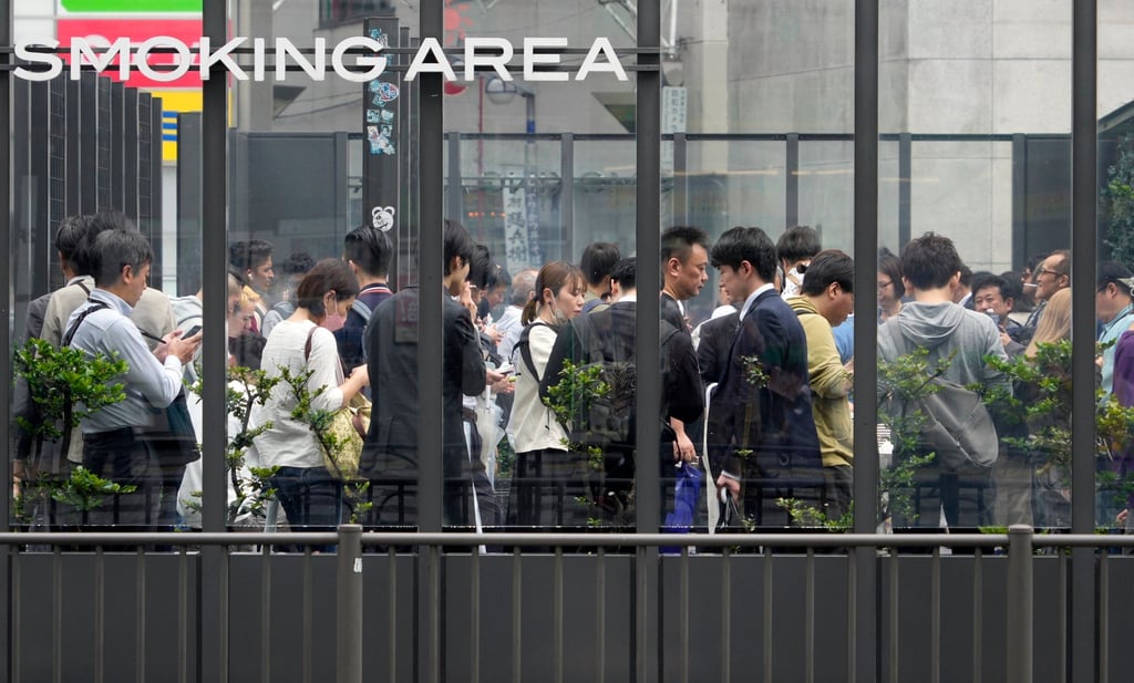 Smokers congregate at a designated smoking area in Tokyo. Photo: EPA-EFE