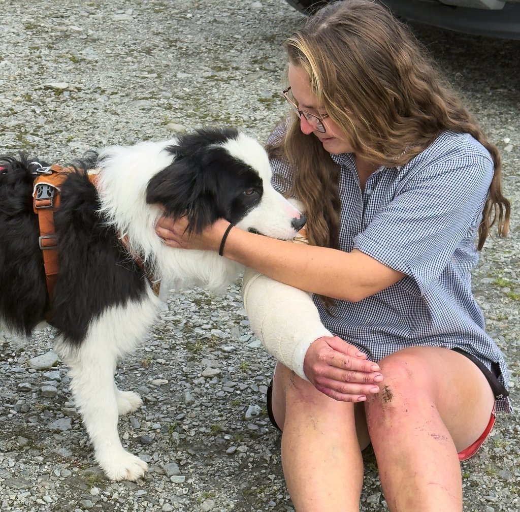 Molly is reunited with her owner, Jessica Johnston, after being rescued from a waterfall on the Arahura River in New Zealand on Tuesday. Photo: Precision Helicopters/AP