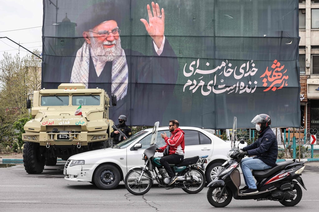 Commuters ride past a banner honouring Iran’s late Ayatollah Ali Khamenei in Tehran on Tuesday. Photo: AFP Commuters ride past a banner honouring Iran’s late Ayatollah Ali Khamenei in Tehran on Tuesday. Photo: AFP