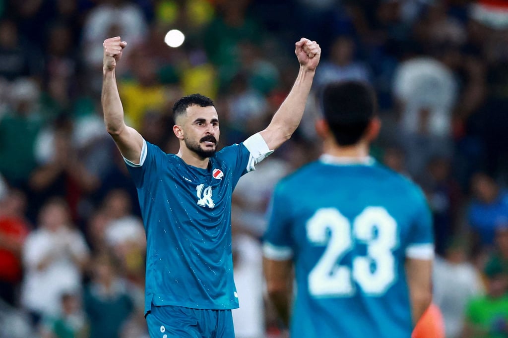 Aymen Hussein celebrates scoring Iraq’s second and winning goal against Bolivia. Photo: Reuters