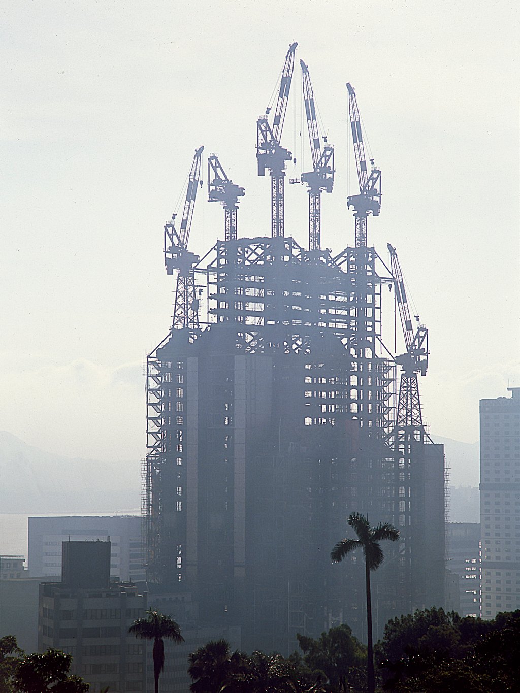 The completed main framework is picked out in early-morning mist in June 1984. The first of the six cranes is being dismantled and is minus its jib (second left). Photo: Ian Lambot The completed main framework is picked out in early-morning mist in June 1984. The first of the six cranes is being dismantled and is minus its jib (second left). Photo: Ian Lambot