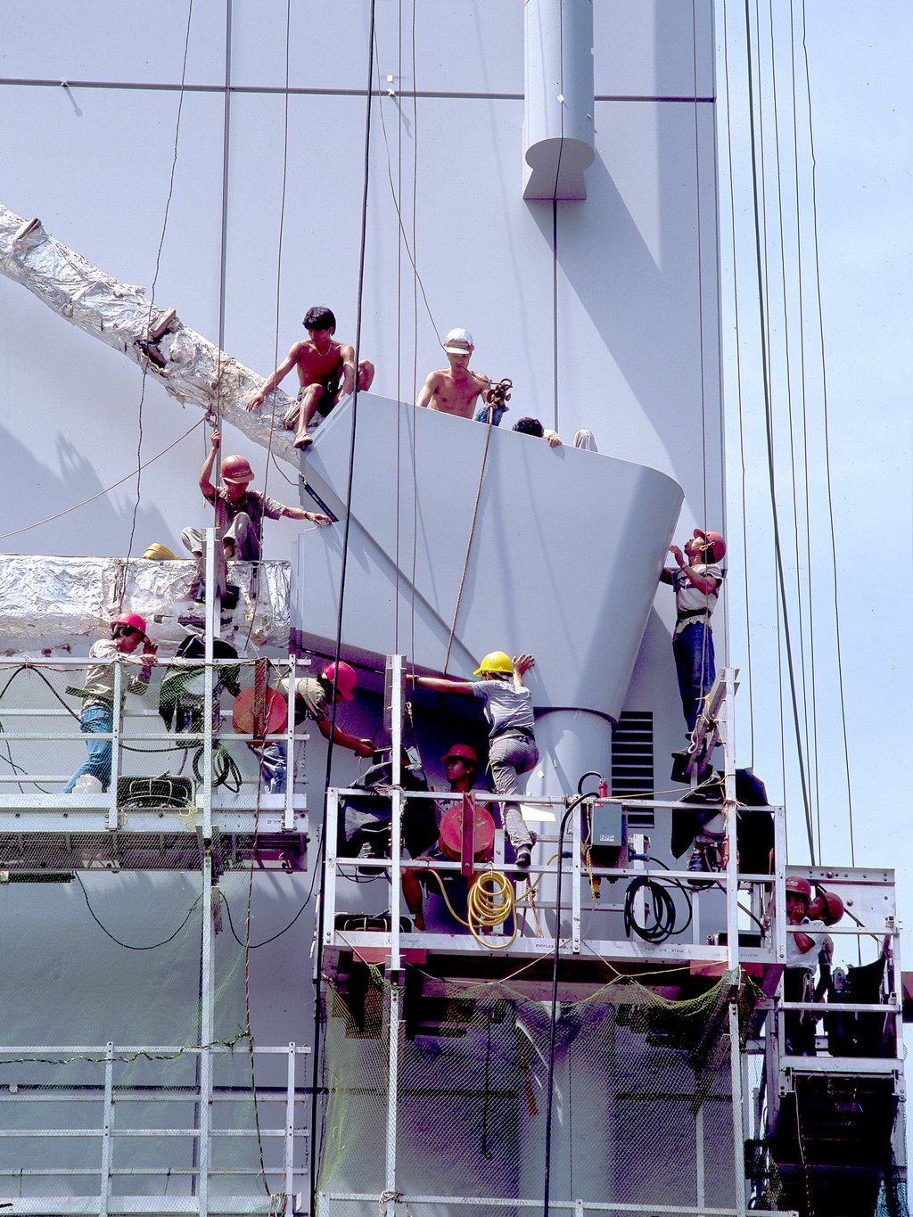 One of the largest external aluminium cladding sections is manoeuvred into place in August 1984. The cladding was designed to prevent water penetration, especially during typhoons. Photo: Ian Lambot One of the largest external aluminium cladding sections is manoeuvred into place in August 1984. The cladding was designed to prevent water penetration, especially during typhoons. Photo: Ian Lambot