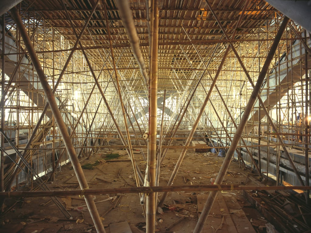 This elaborate bamboo structure was erected on level 11 adjacent to the atrium to help with the installation of soffit cladding, which protects against moisture and condensation. Photo: Ian Lambot This elaborate bamboo structure was erected on level 11 adjacent to the atrium to help with the installation of soffit cladding, which protects against moisture and condensation. Photo: Ian Lambot