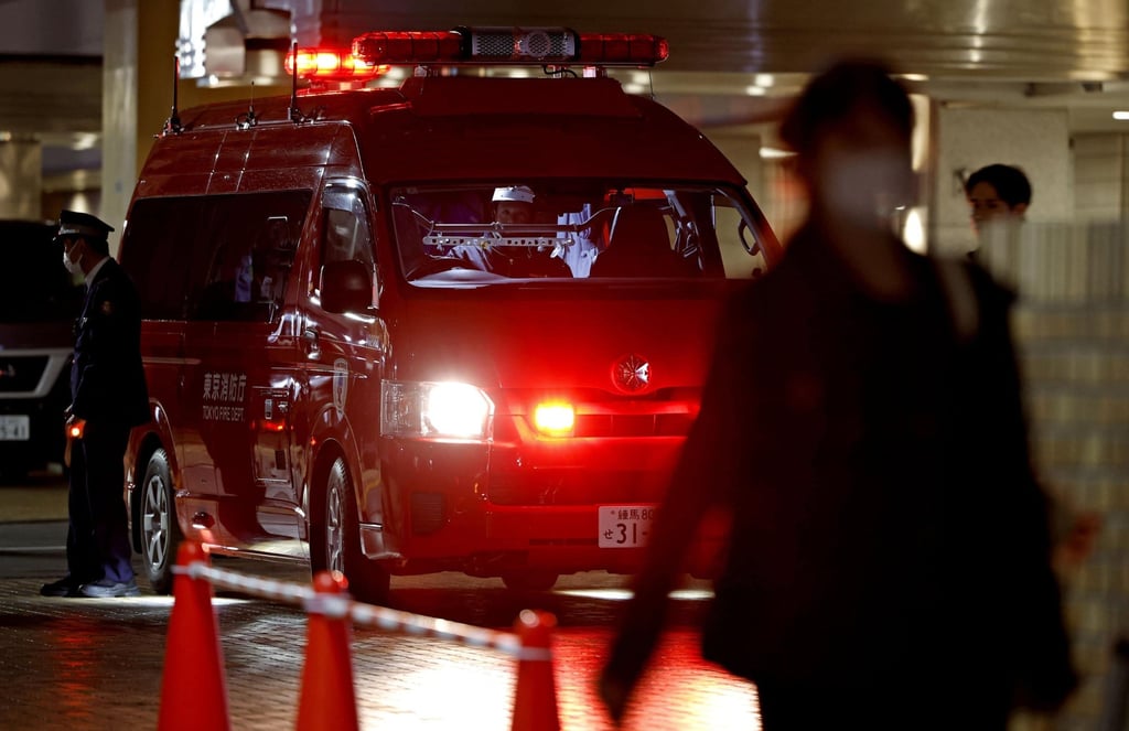 Police and emergency responders stand by at the scene of a deadly stabbing in downtown Tokyo on March 26. Photo: Kyodo/AP