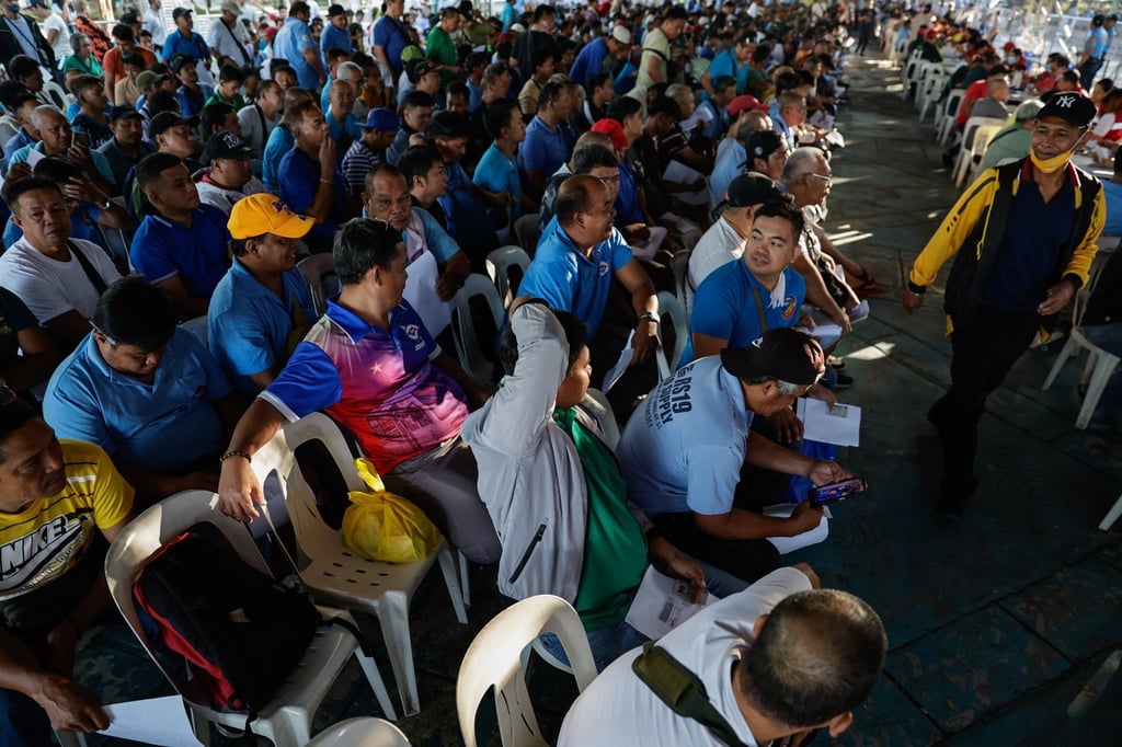 Drivers of jeepneys, or local minibuses, queue to receive a fuel subsidy of 5,000 pesos through a government social welfare programme in Quezon City, Metro Manila, the Philippines, on March 25. Photo: EPA