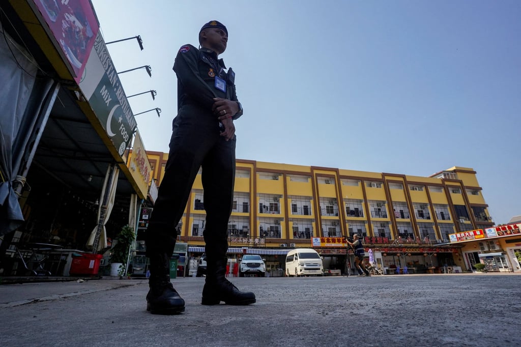A Cambodian police officer stands guard near a deserted scam compound in Kampot province, Cambodia, in February. Photo: Reuters