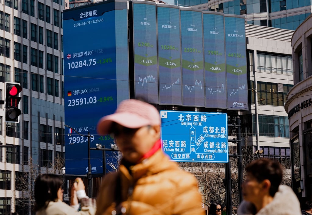 A large screen shows stock exchange and economy data in Shanghai. Photo: EPA