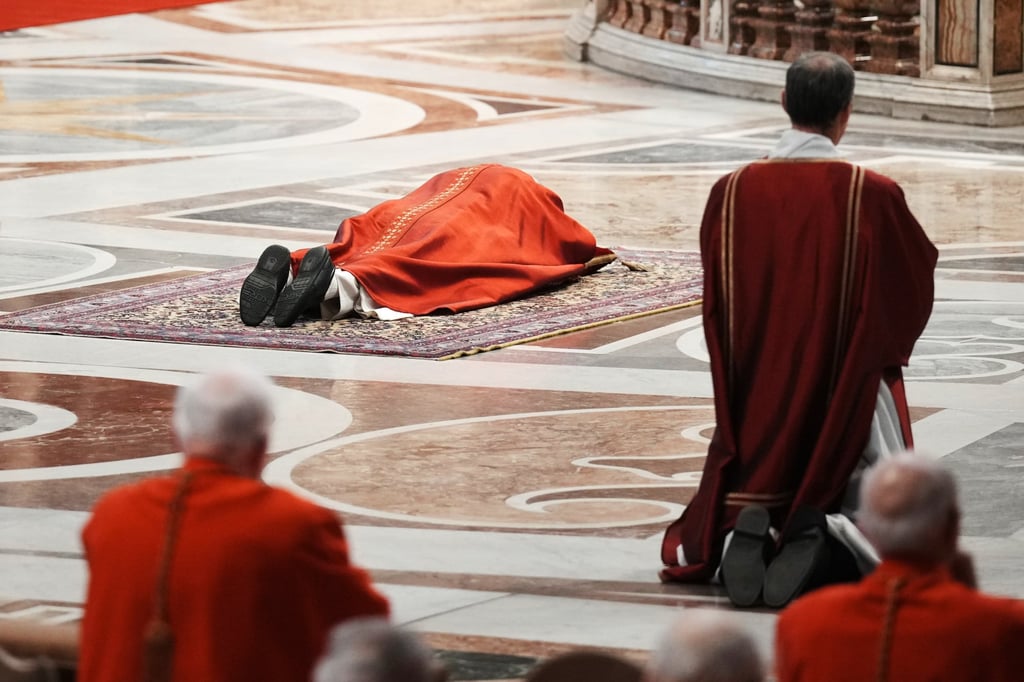 Pope Leo lies prostrate at the Celebration of the Passion of the Lord in St Peter’s Basilica on Good Friday. Photo: AP