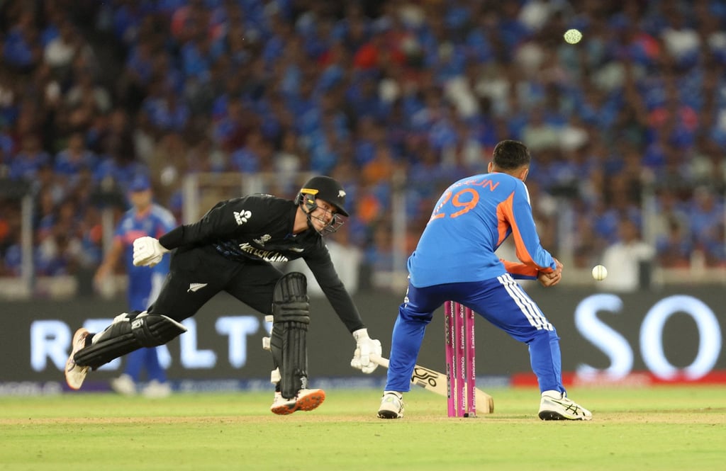 Mark Chapman races to make his ground in a T20 World Cup final watched by nearly 87,000 people. Photo: Reuters